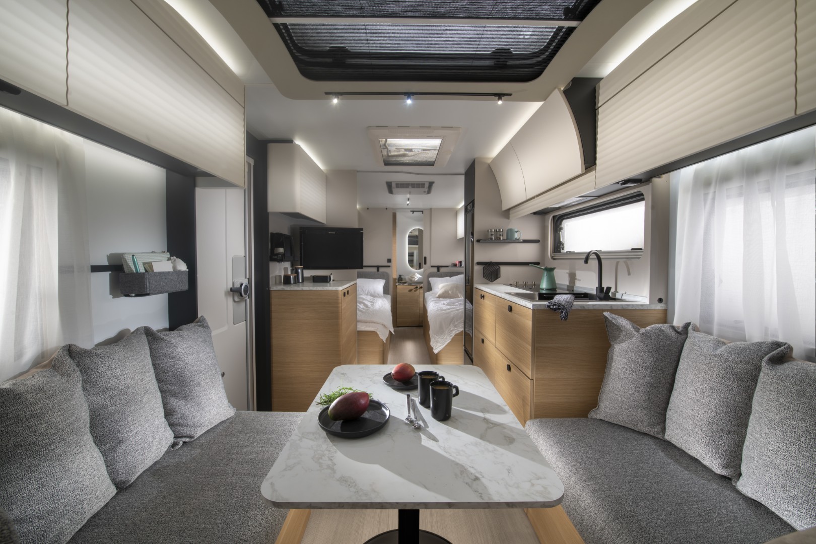 Adria Adora 572 UT avec salon en U à l'avant, lits simples à l'arrière et salle de bains attenante.
