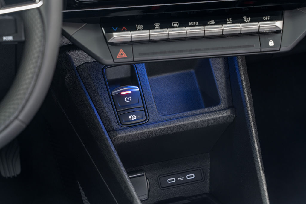 Content detailed shot of interior console showing air condition buttons  two usb c ports   storage