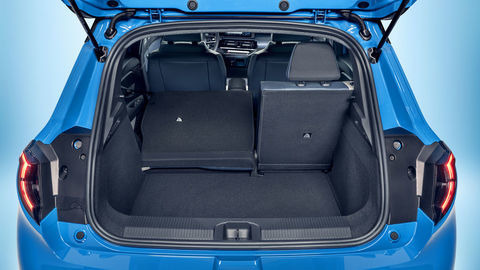 Thumb focused view of micra s empty trunk space with open trunk door and one collapsed seat