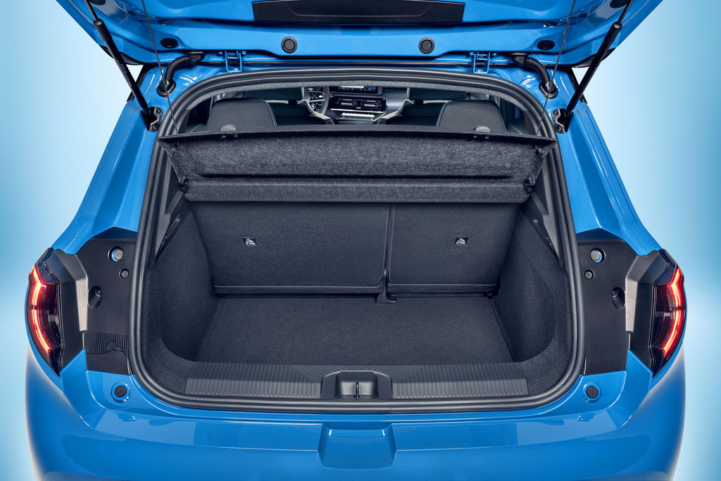 Content focused view of micra s empty trunk space with open trunk door and upright seats