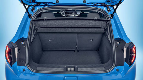 Thumb focused view of micra s empty trunk space with open trunk door and upright seats