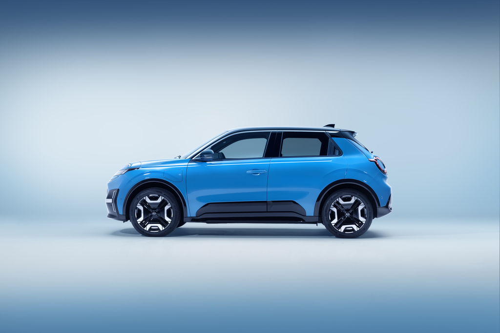Content side profile view of all new nissan micra in gear blue body color and black roof