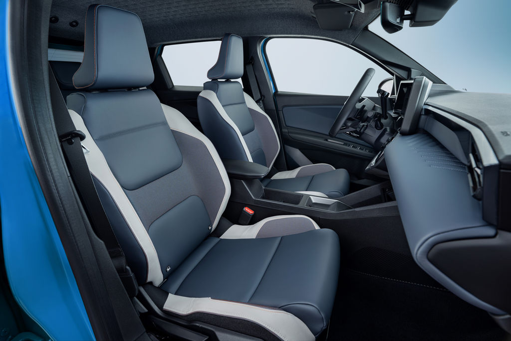 Content side view of micra front seats from passenger side door pov revealing leather materials  steering wheel and dashboard