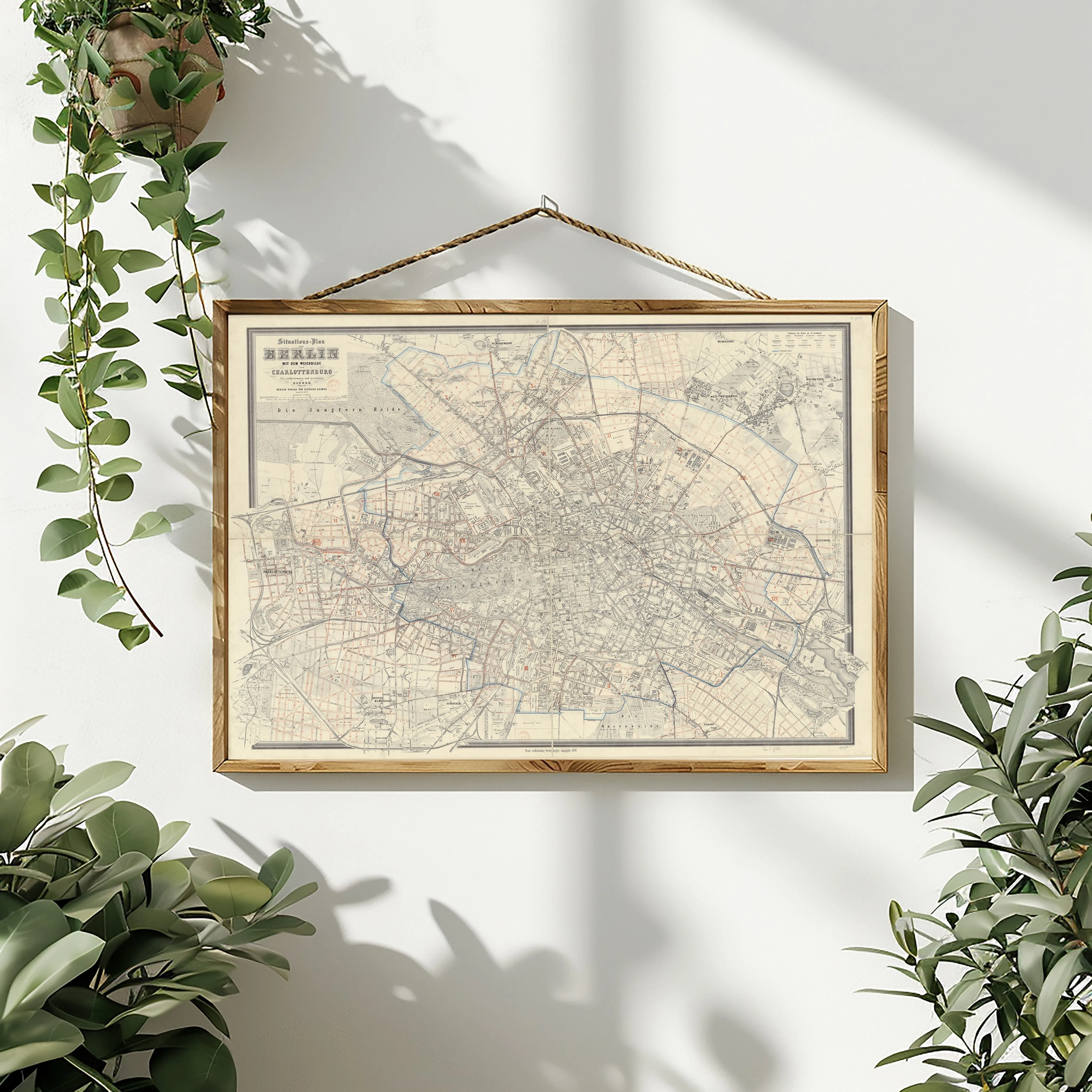 This image features a beautifully framed map, titled "maps 4," hanging elegantly on a white wall amidst greenery. The map itself is displayed in a vintage style, with a detailed and abstract representation of某个地区 或城市的布局.