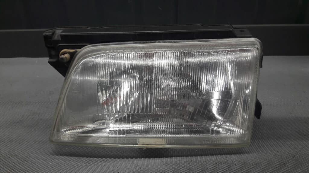90181002 reflektor lewy OPEL KADETT E 88r