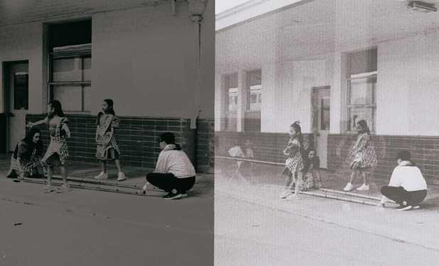 a scan of a black and white ish film photo of two scenes, side by side, one is darker and one is lighter. both sides show kids practicing a dance with some poles and their family members arranging the poles on the ground
