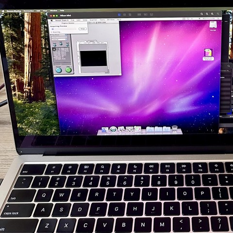 A photo of a Mac mini with Leopard inside a screenshare application in a modern Mac