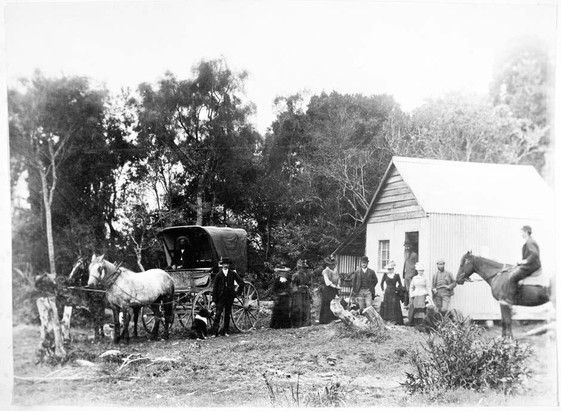 photo of a rural polling station in 1893 including some women lined up by the door