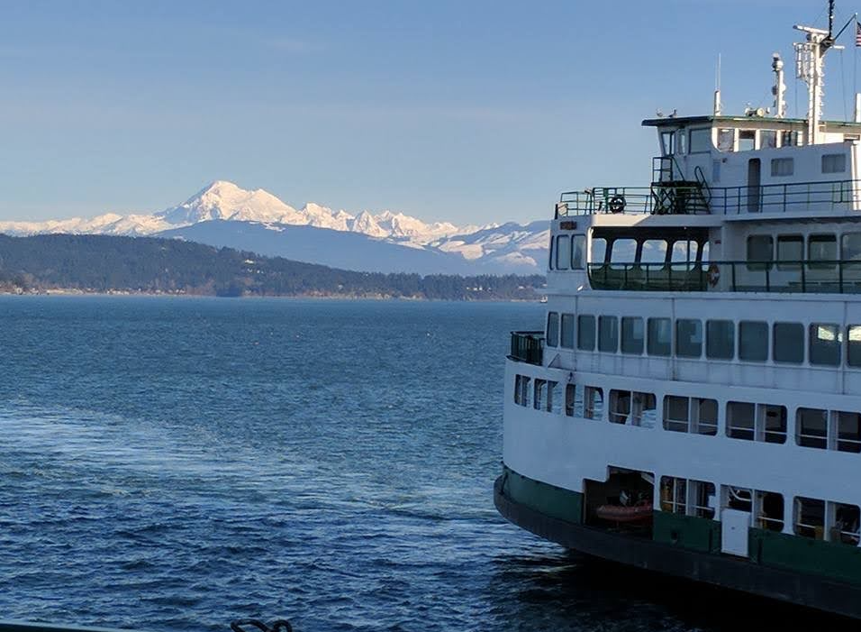 Ferry boat with beautiful snowy mountains in the background. 