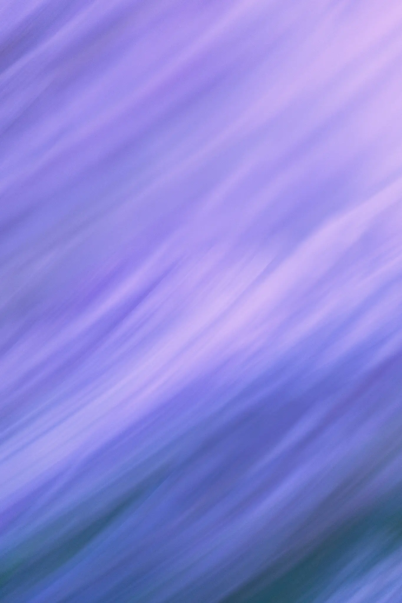 An abstract image featuring diagonal streaks of blurred purple and lavender, transitioning to darker blue-green at the…