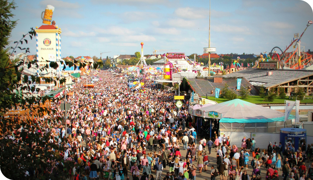 A vibrant festival seen from above, with colourful crowds and lively outdoor activities