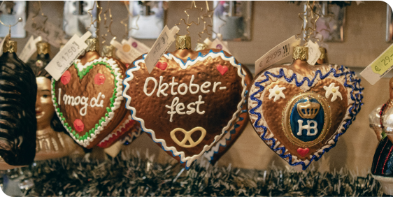 Heart-shaped cookies with 'Oktoberfest' written on them, decorated in colourful icing