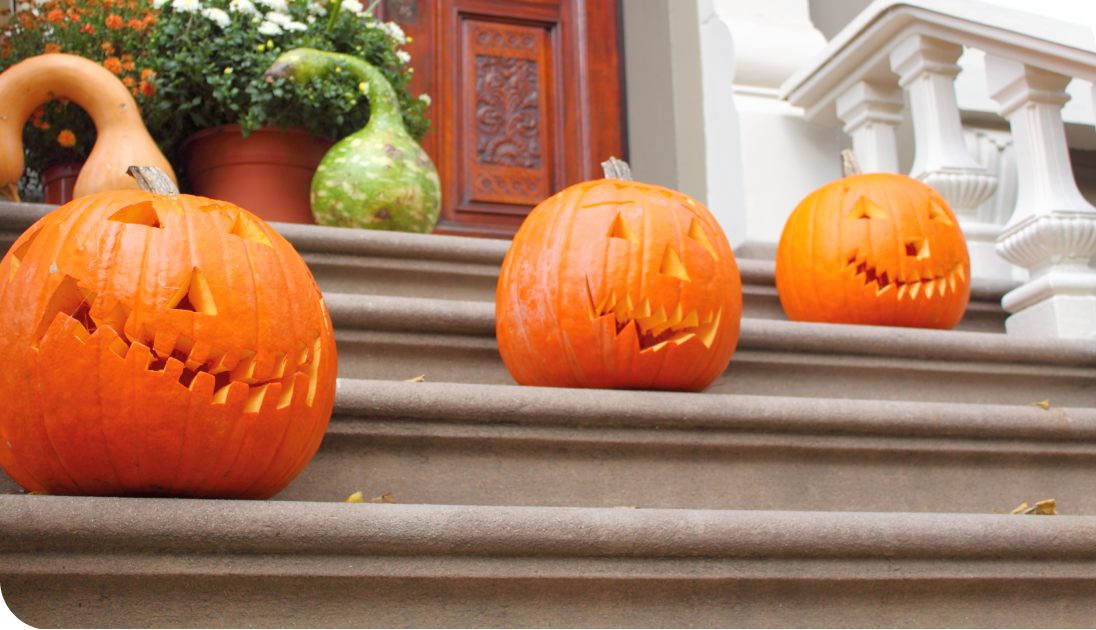 Carved pumpkins on a doorstep, ready for Halloween