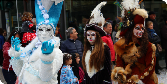 People in costumes parade through the city