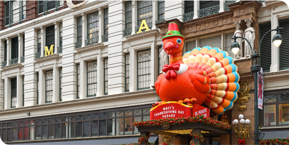 A giant inflatable turkey stands tall in front of Macy's for Thanksgiving