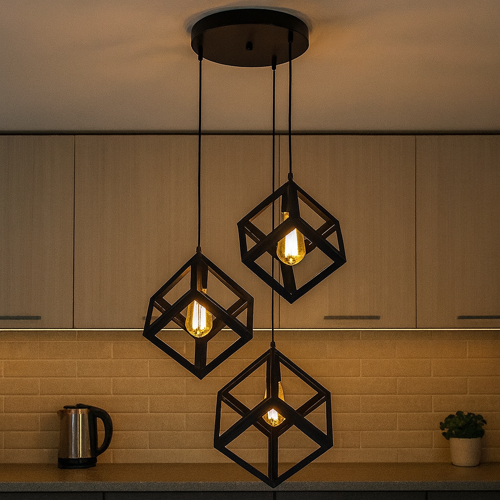 Подвесная люстра с тремя чёрными металлическими кубами разного размера, размещена в студии в Одессе, минимализм, направленный свет, регулируемая высота для зонирования интерьера.