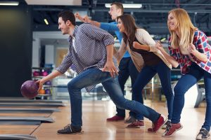 friends-cheering-their-friend-while-throwing-bowling-ball-300x200