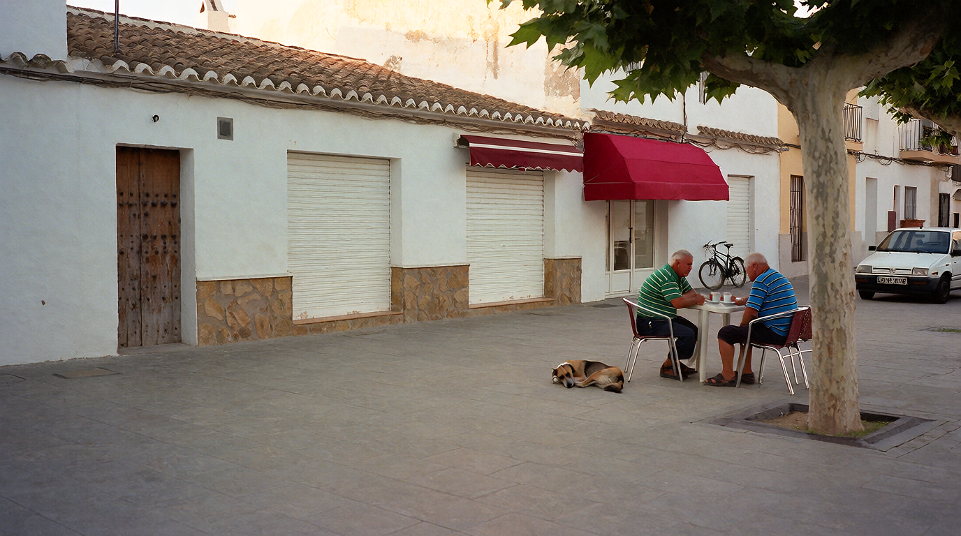 A quiet plaza in the afternoon with two men lingering over coffee under a plane tree