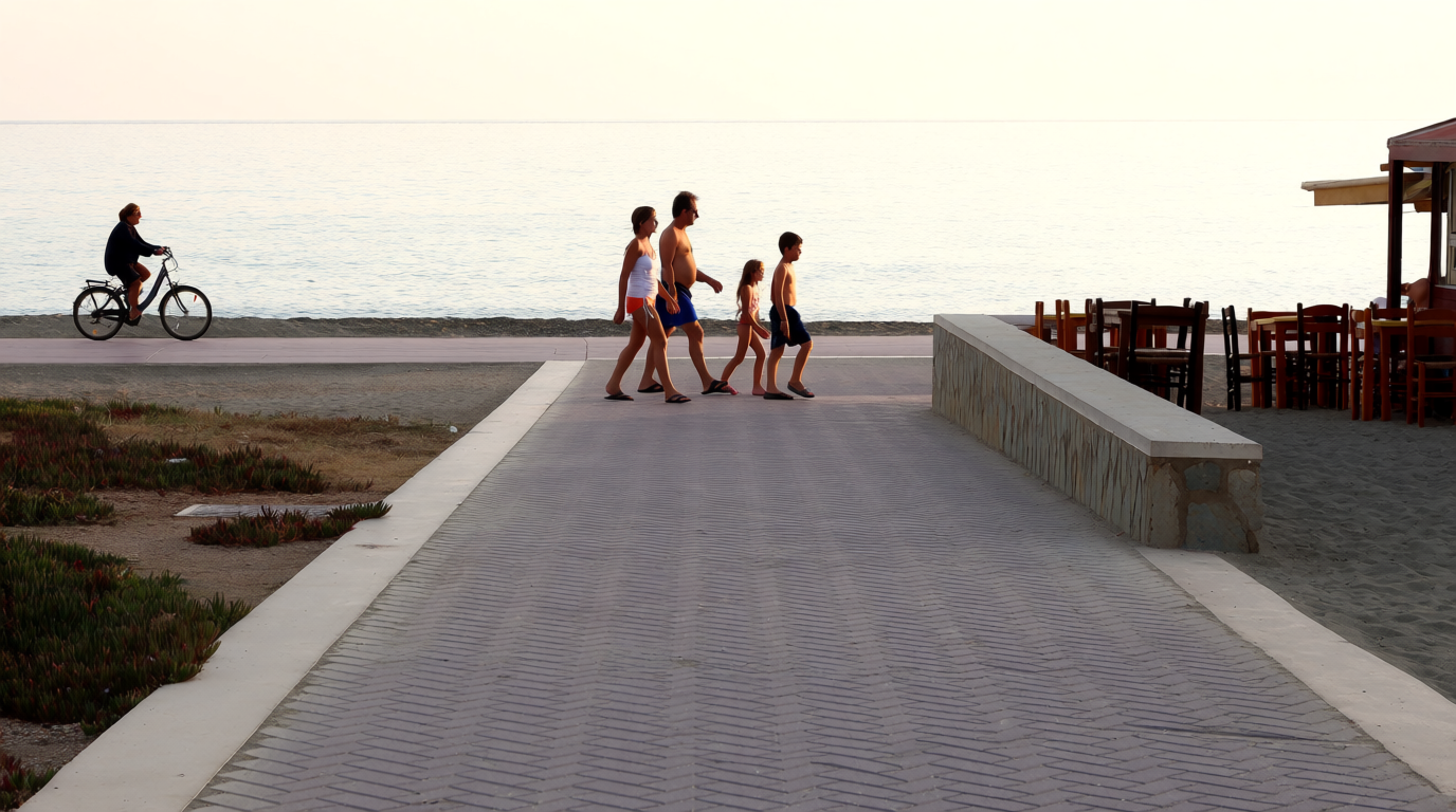 A family walking the promenade at La Cala de Mijas in late afternoon