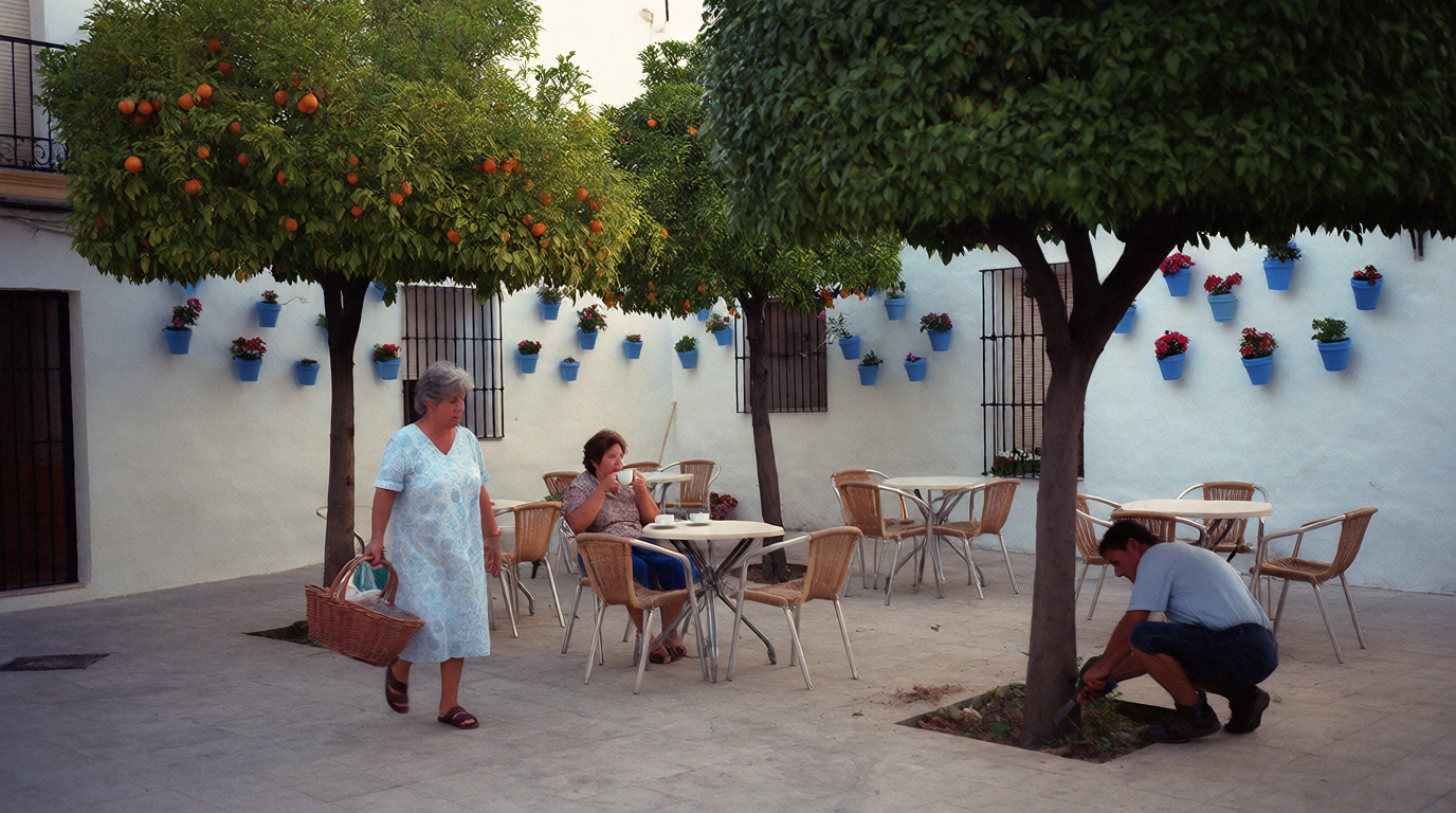 A quiet square in Estepona with orange trees and café tables in the morning