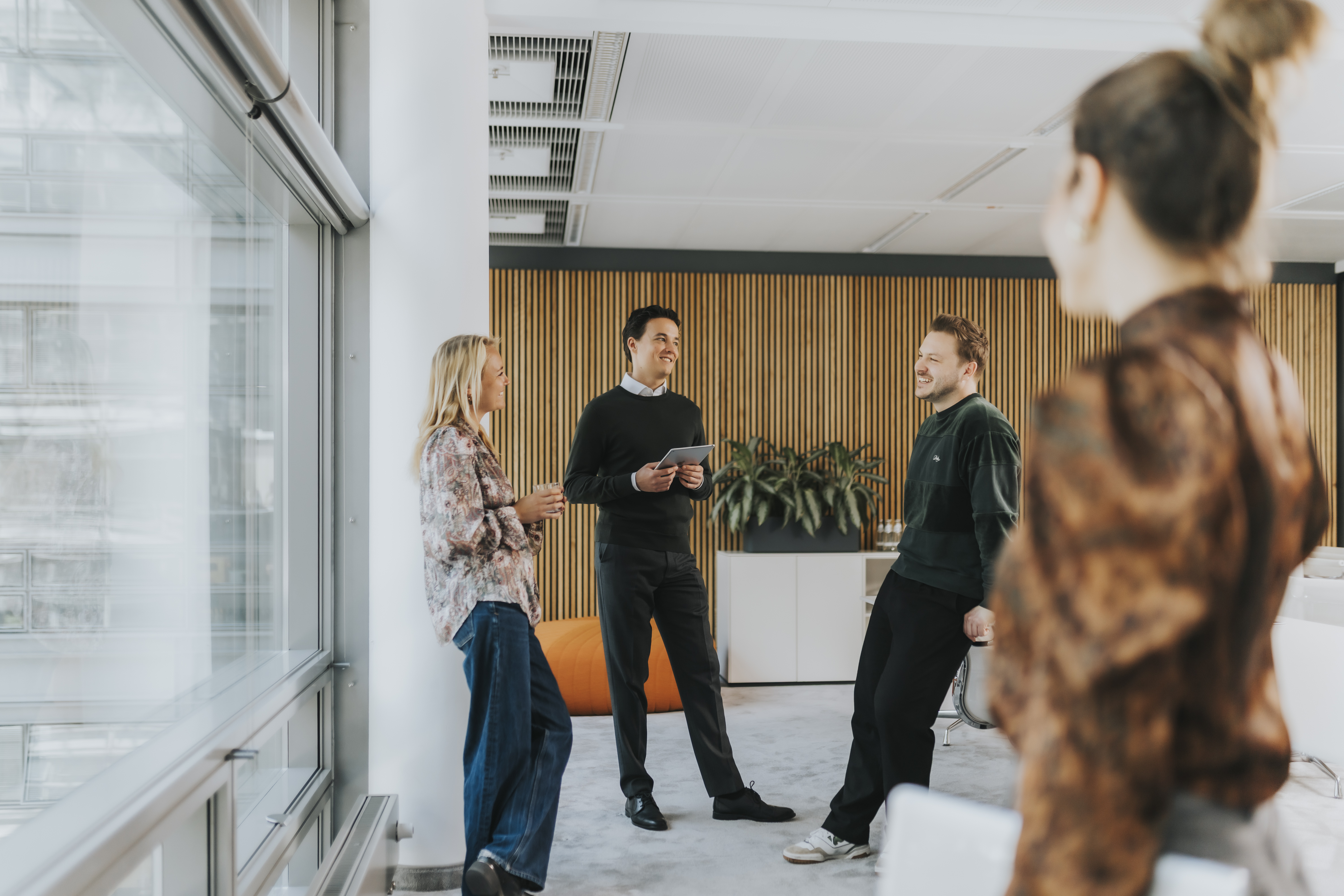Image of four people standing in an office