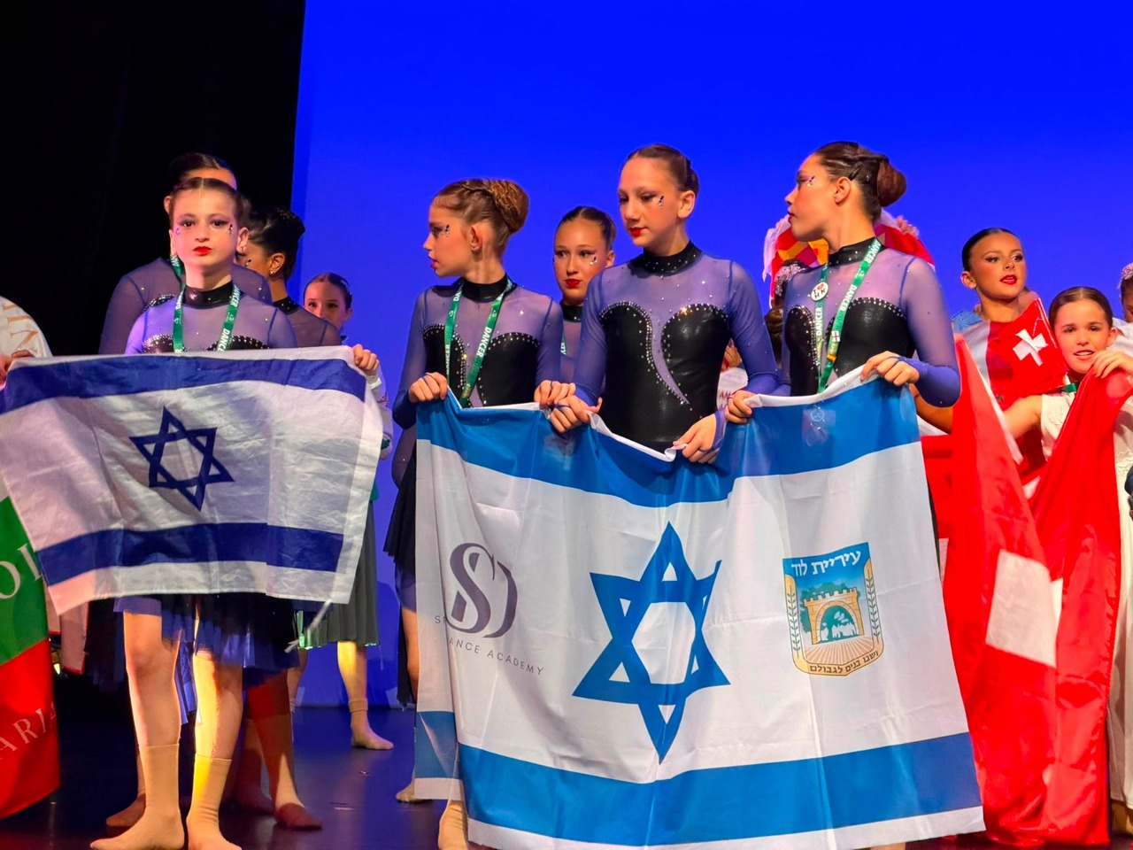 מתעמלות הסטודיו של ספקטור דנסינג עם דגלי ישראל ולוד באליפות העולם