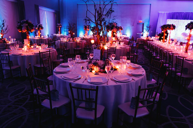 decorated-wedding-hall-with-candles-round-tables-centerpieces_8353-10057