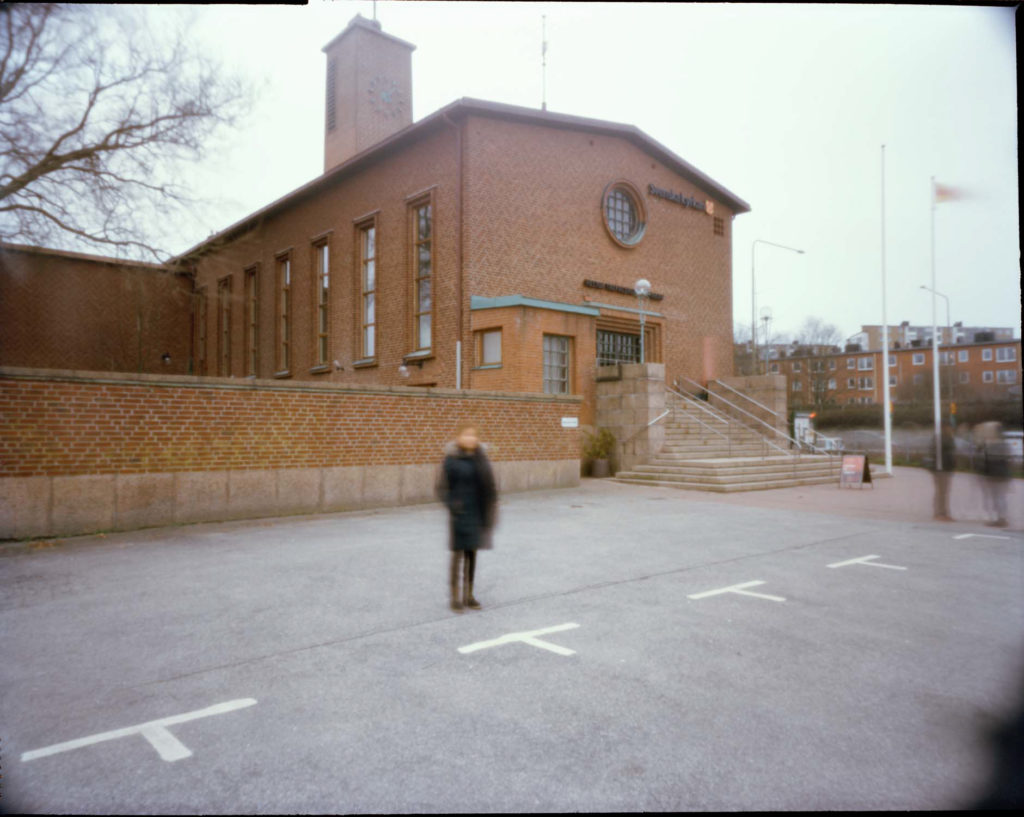 An image of an out of focus female refugee outside of the Swedish Church in Malmo, Sweden.