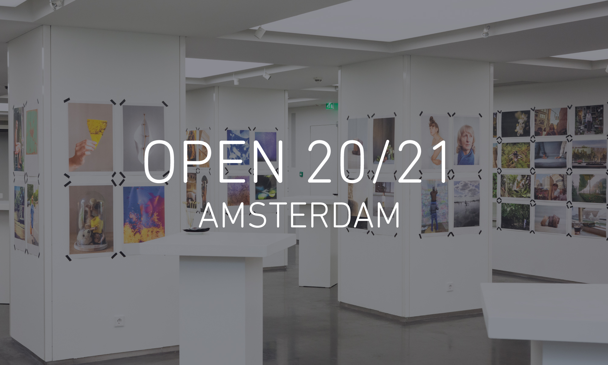 Image of the OPEN 2018 Amsterdam exhibition, with Newspaper Club prints taped to walls and pillars at 5&33 Gallery, with text reading 'OPEN 20/21 AMSTERDAM' in the centre