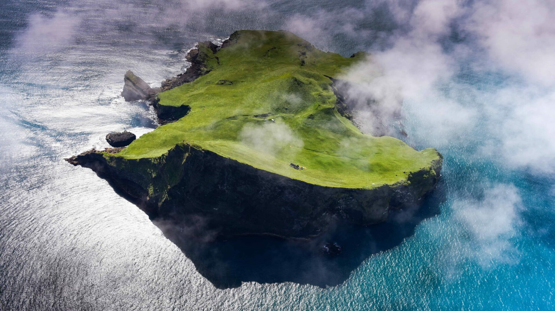 The Westman Islands spread across the sea with Heimaey and surrounding cliffs filling the horizon.