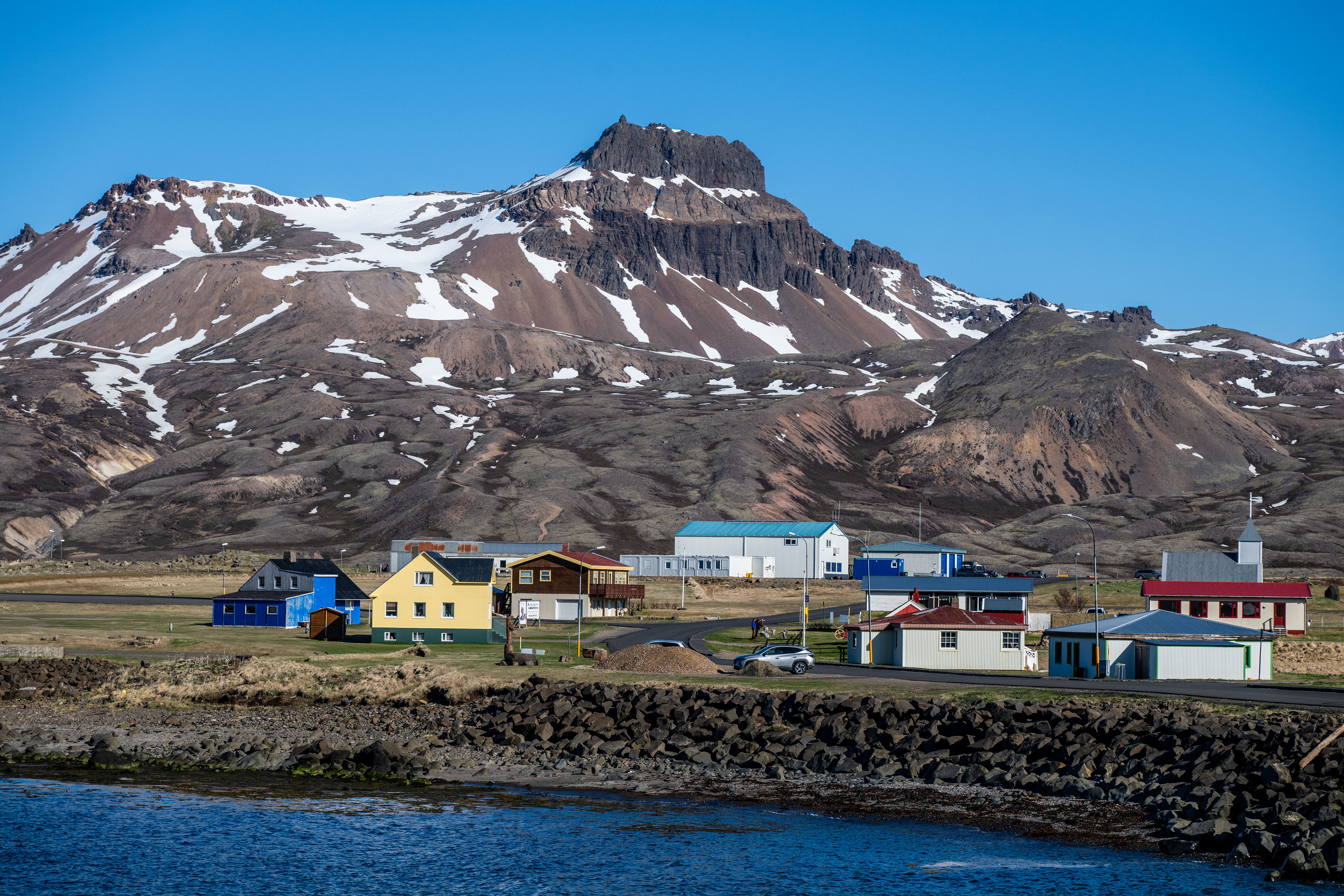 Bakkagerði village below snowy mountains in Borgarfjörður Eystri.