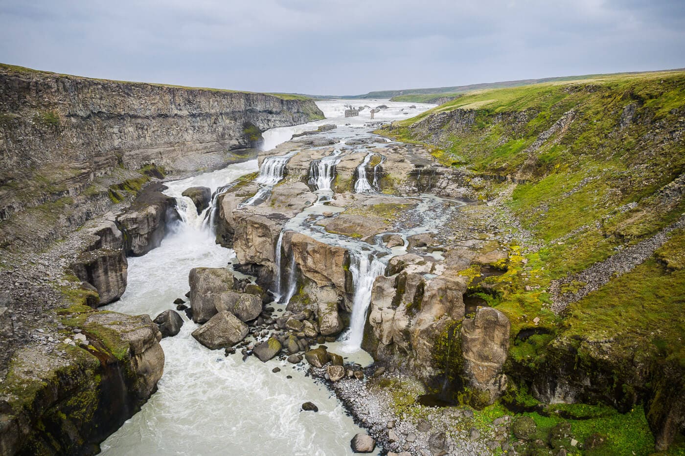 Dynkur waterfall spreading across stepped rock ledges above the Þjórsá canyon.