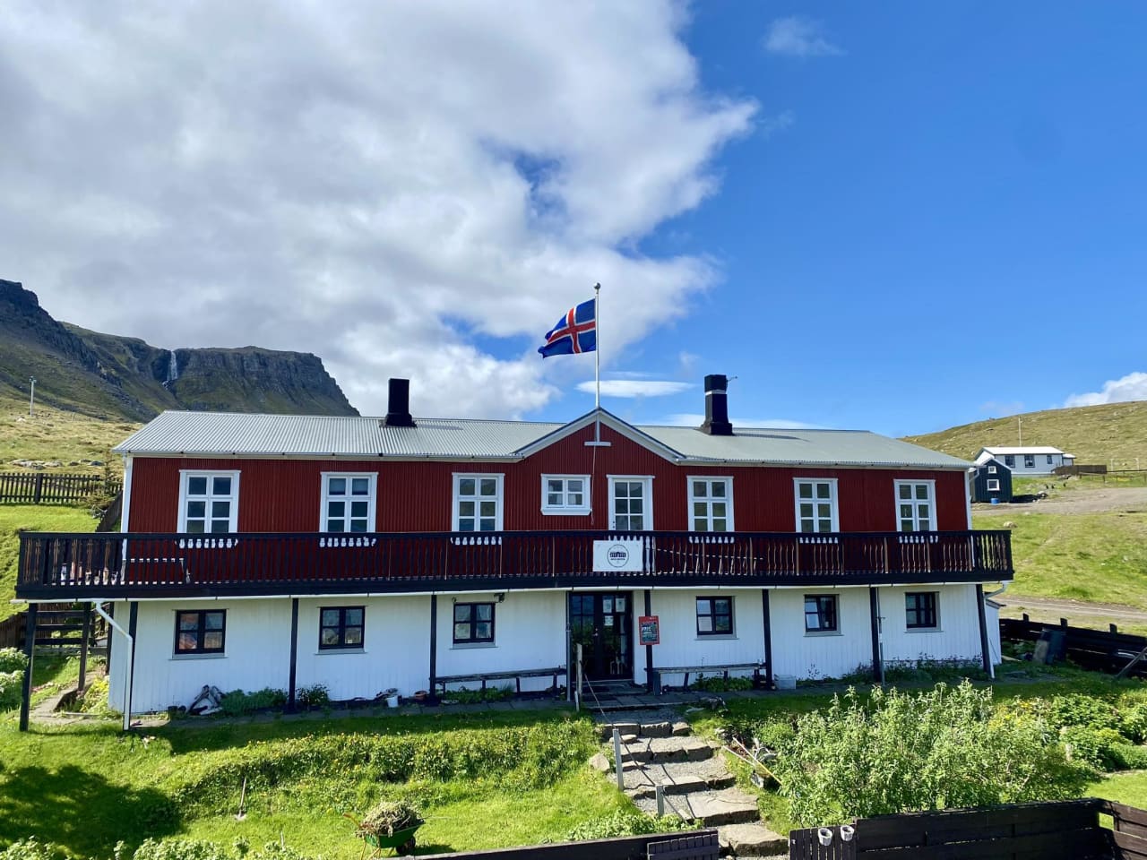 Front of Hotel Djúpavík with the mountain wall rising behind the village.