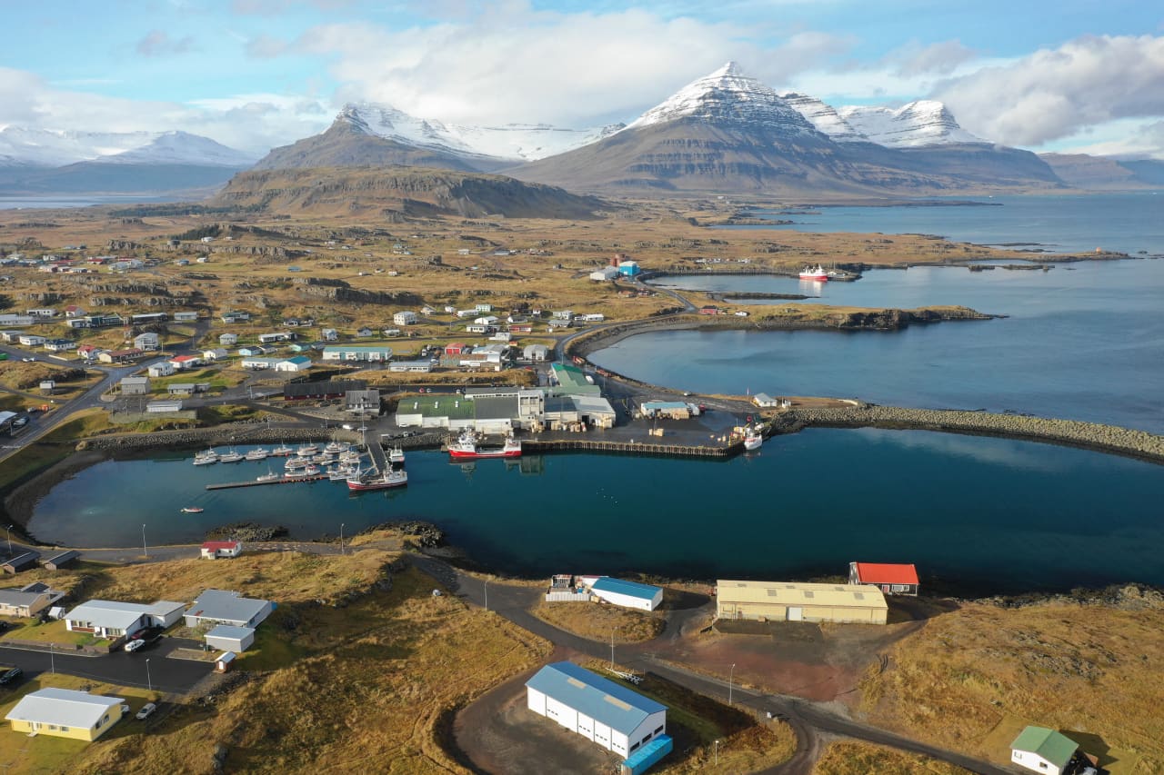 Djúpivogur harbor, houses, and Búlandstindur mountain seen from above in East Iceland.