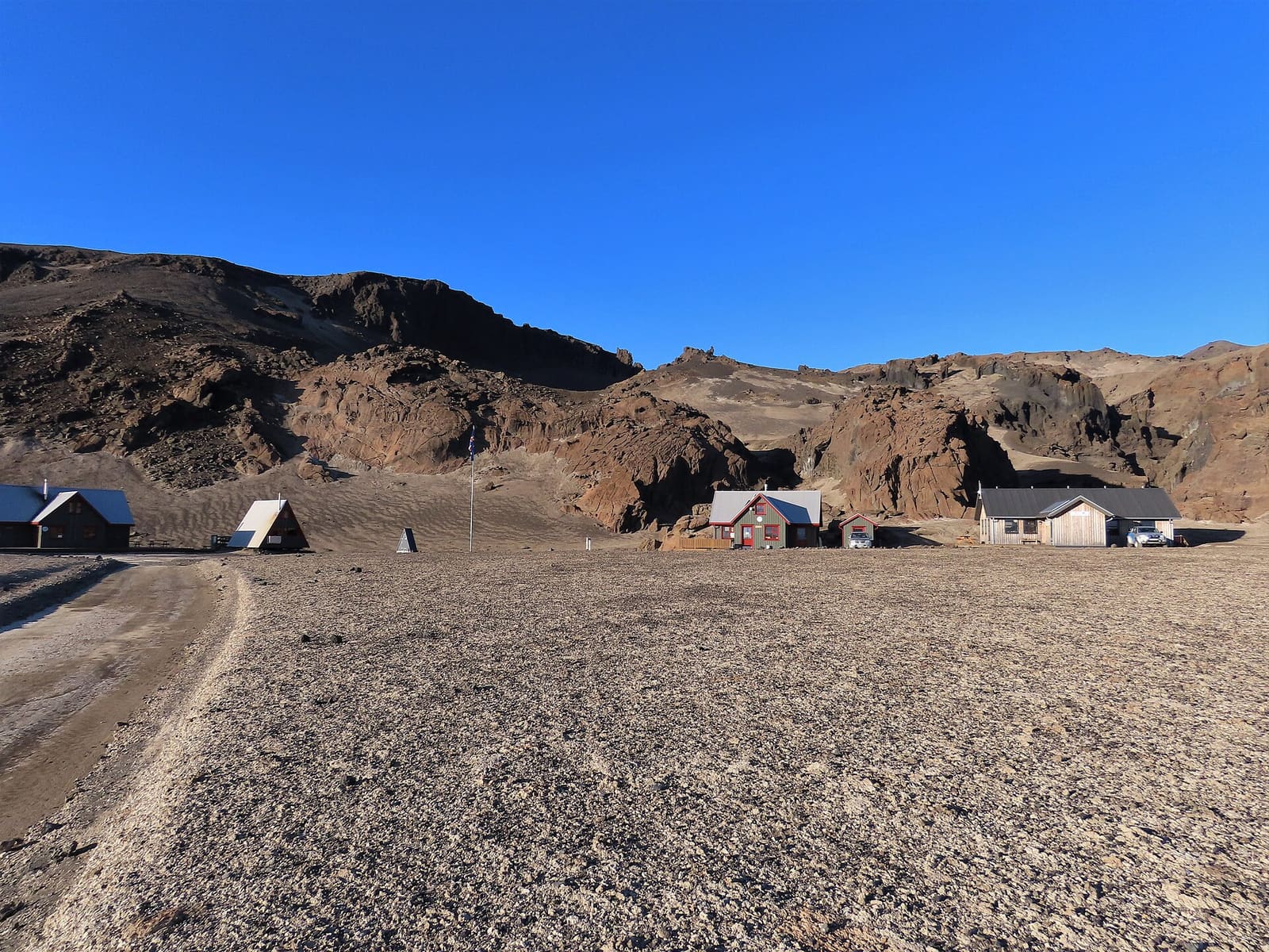 Dreki huts at the mouth of Drekagil in barren Askja Highlands terrain.