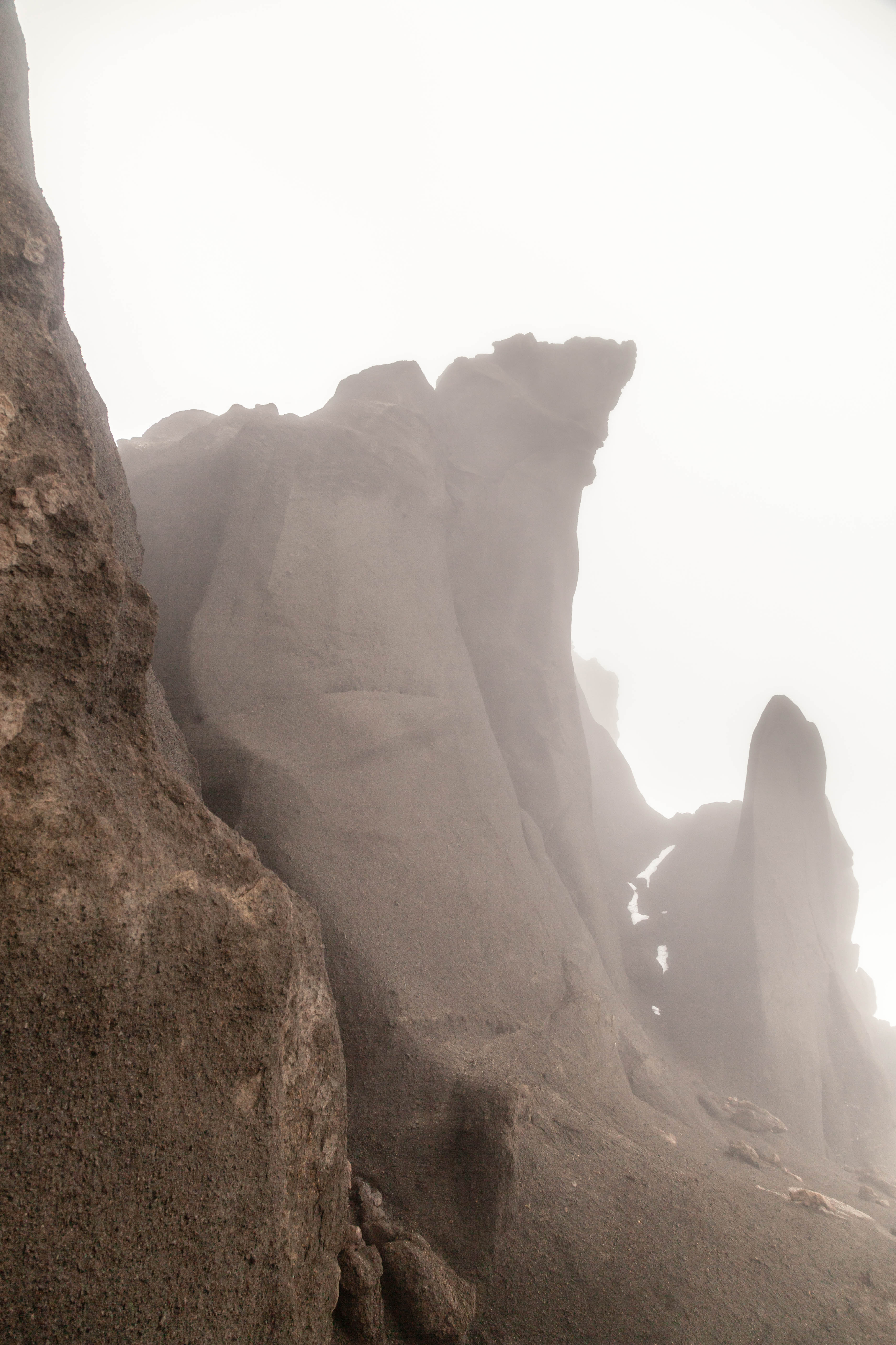 Jagged hyaloclastite formations rising through mist in Drekagil.