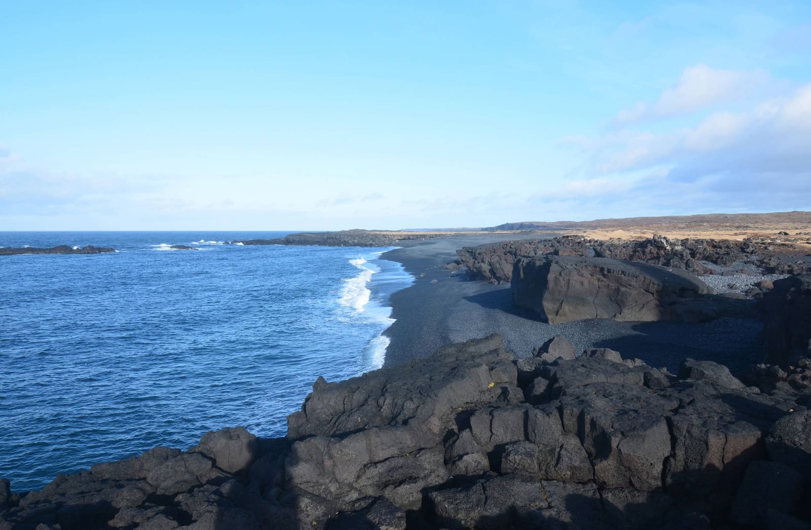 Atlantic surf and dark lava cliffs near Dritvík Cove.