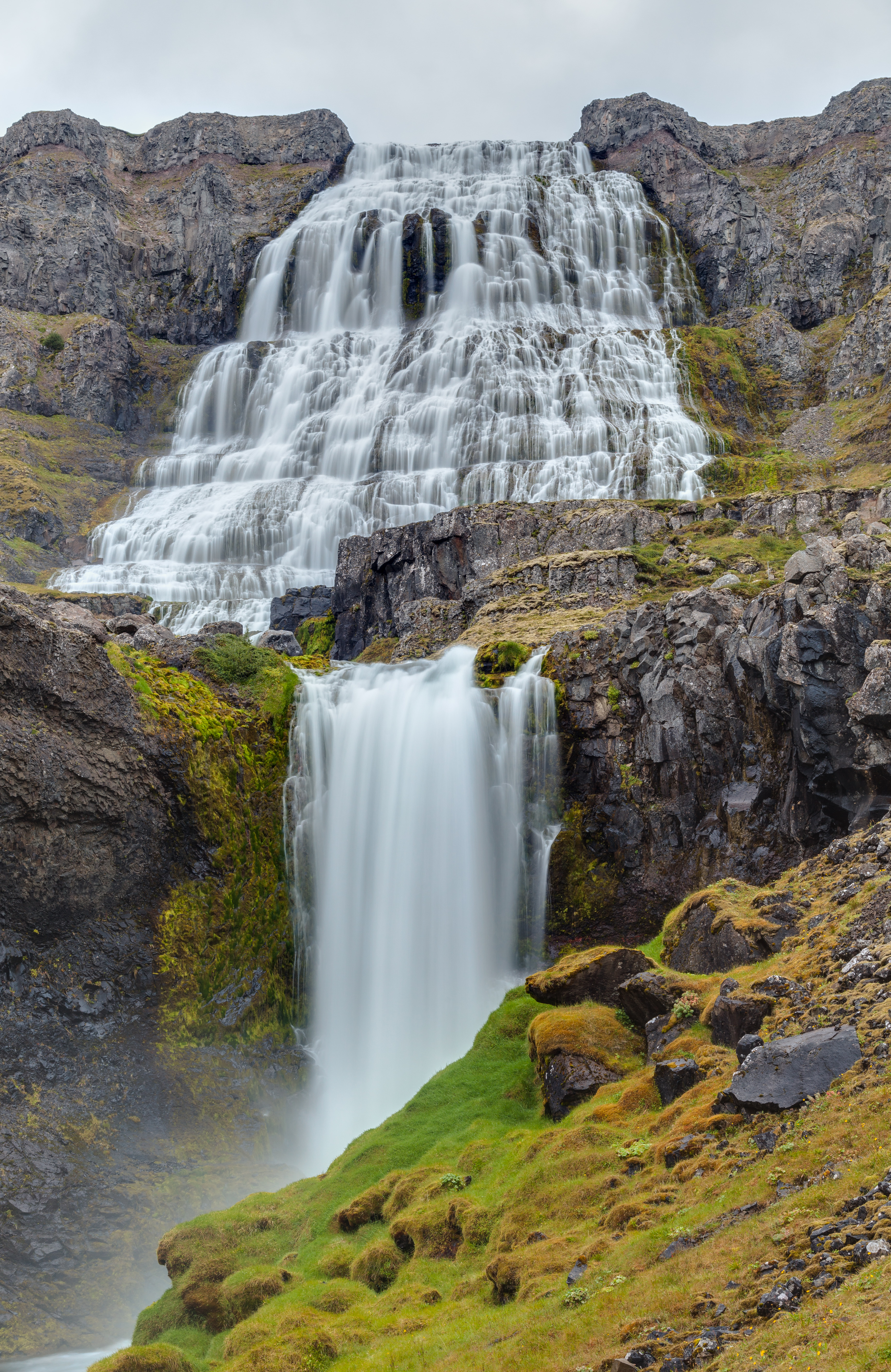 Lower Dynjandi cascade dropping through rocky ledges below the main waterfall.