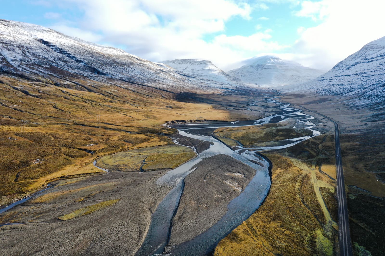 A road crossing open East Iceland valley terrain near the Fljótsdalshérað area.