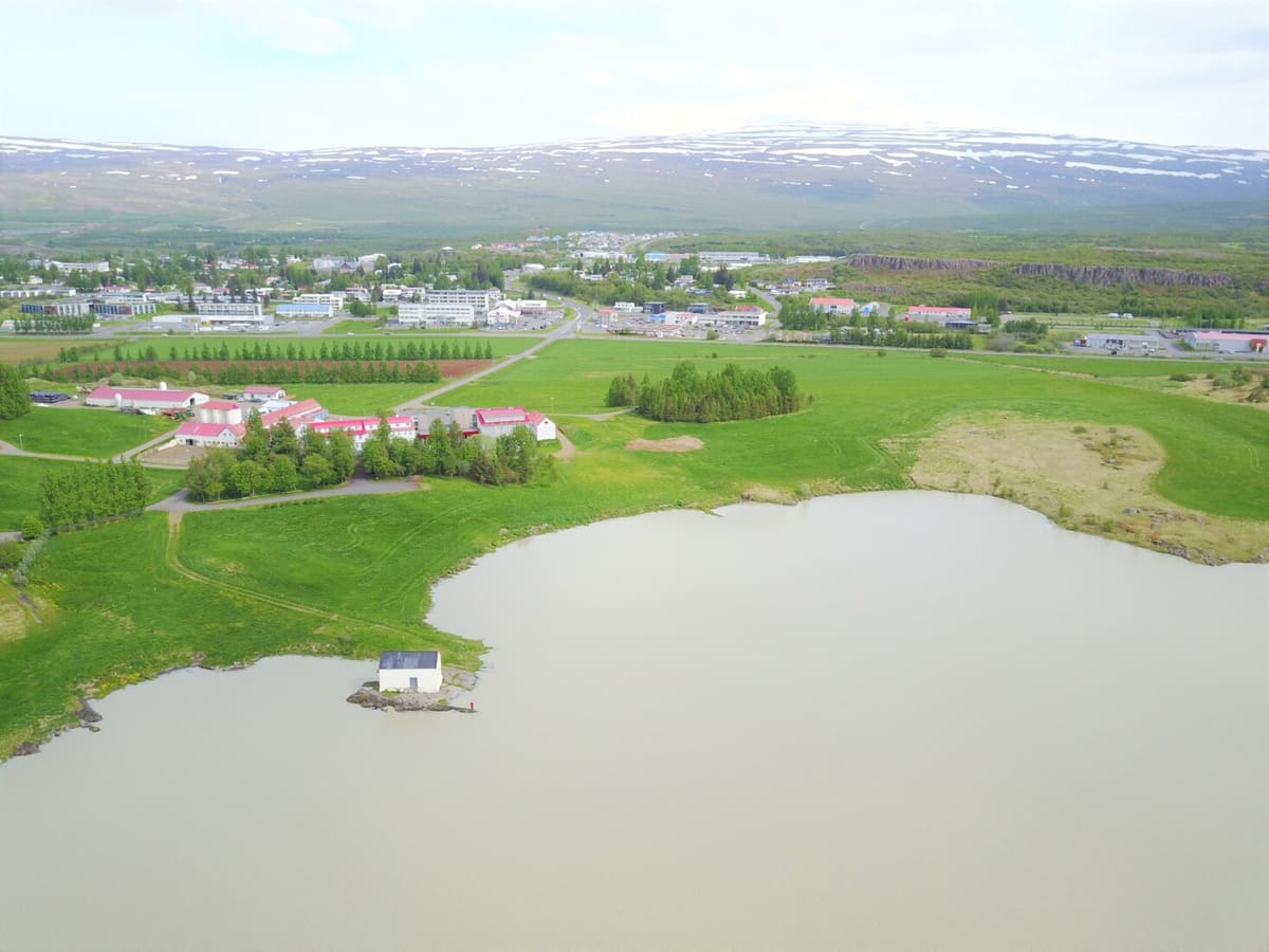 Egilsstaðir streets and buildings in the Fljótsdalshérað area below green East Iceland hills.