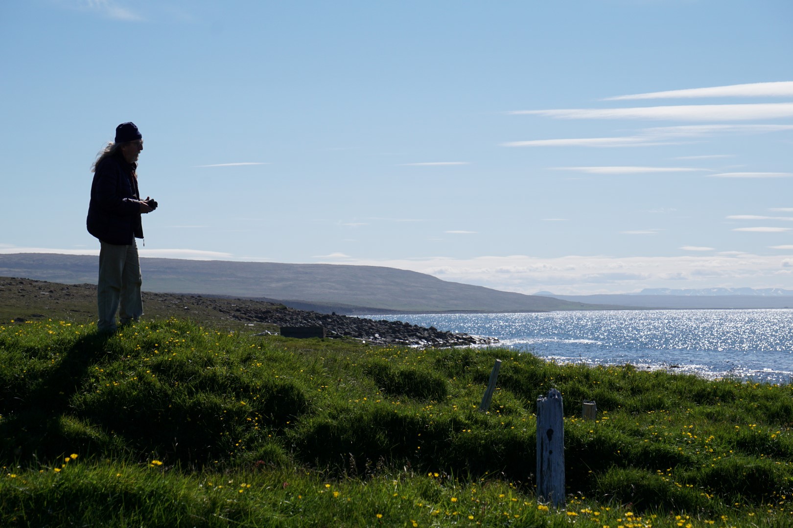 A roofless abandoned building on the Langanes coast with fog over the sea.