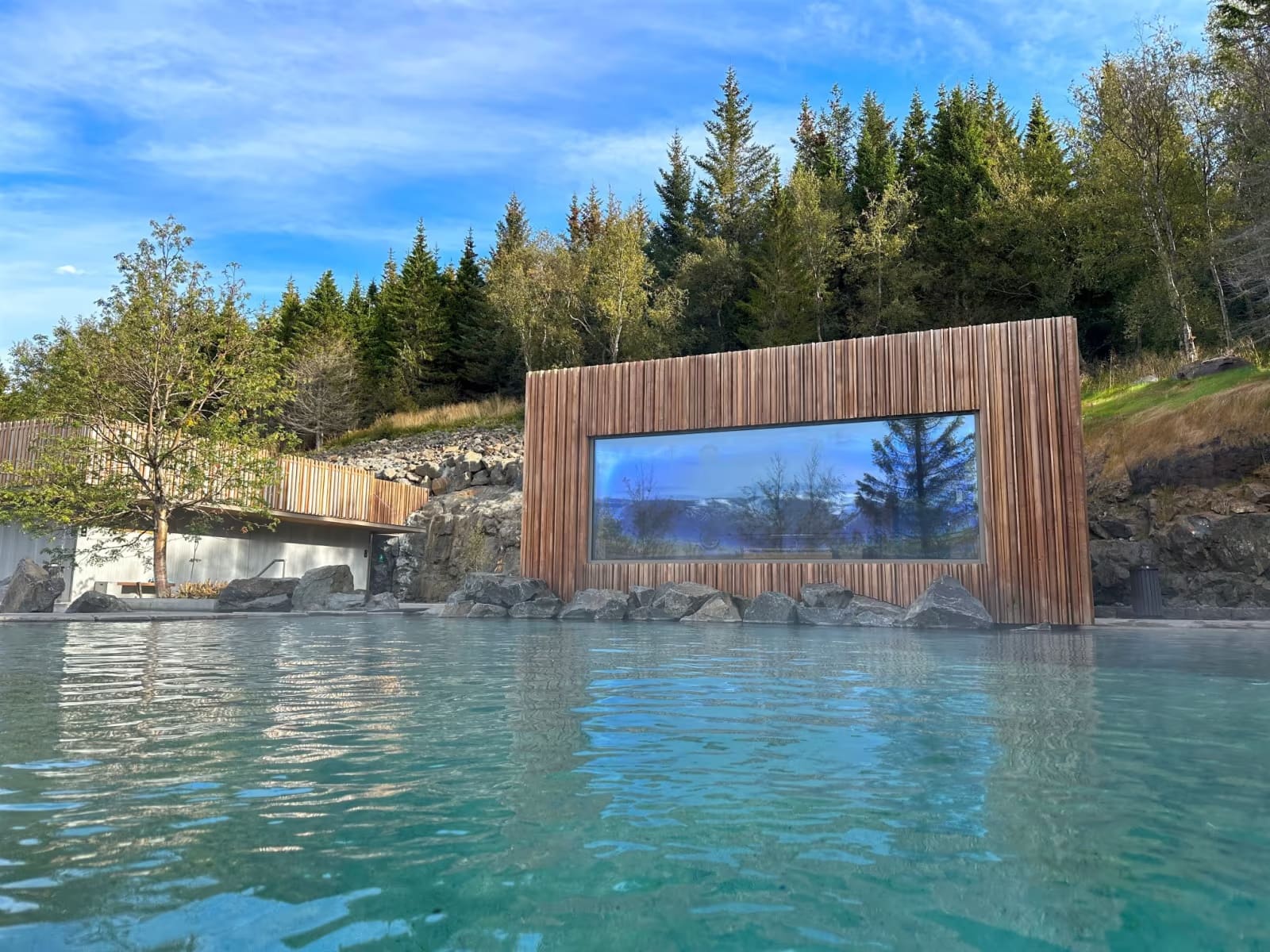 Forest Lagoon’s blue geothermal pools with steam and North Iceland scenery around them.