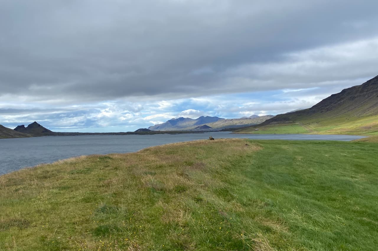 Grassy shoreline and broad water at Hlíðarvatn in Hnappadalur