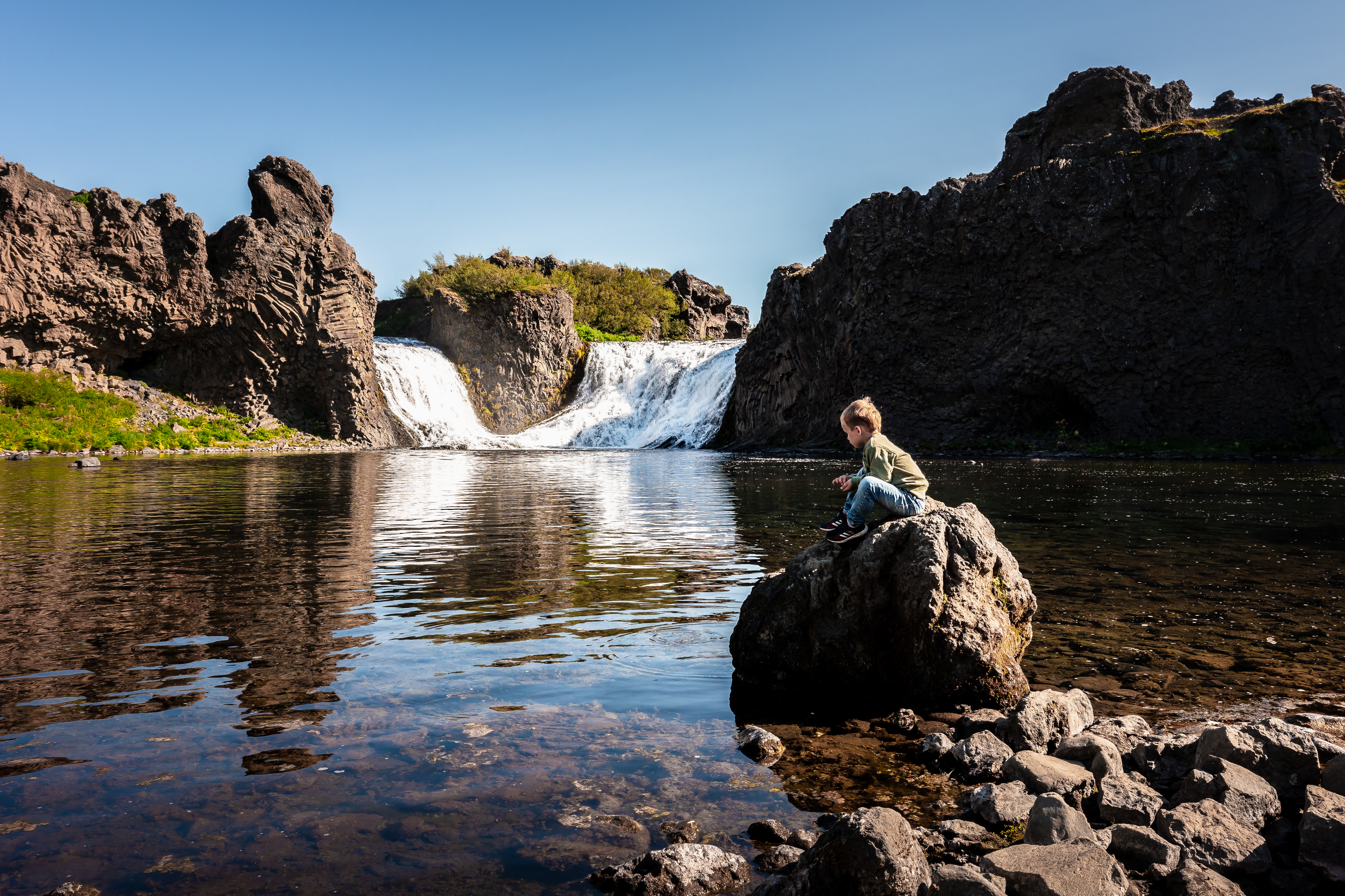 Hjálparfoss waterfall flowing between basalt formations in Þjórsárdalur.