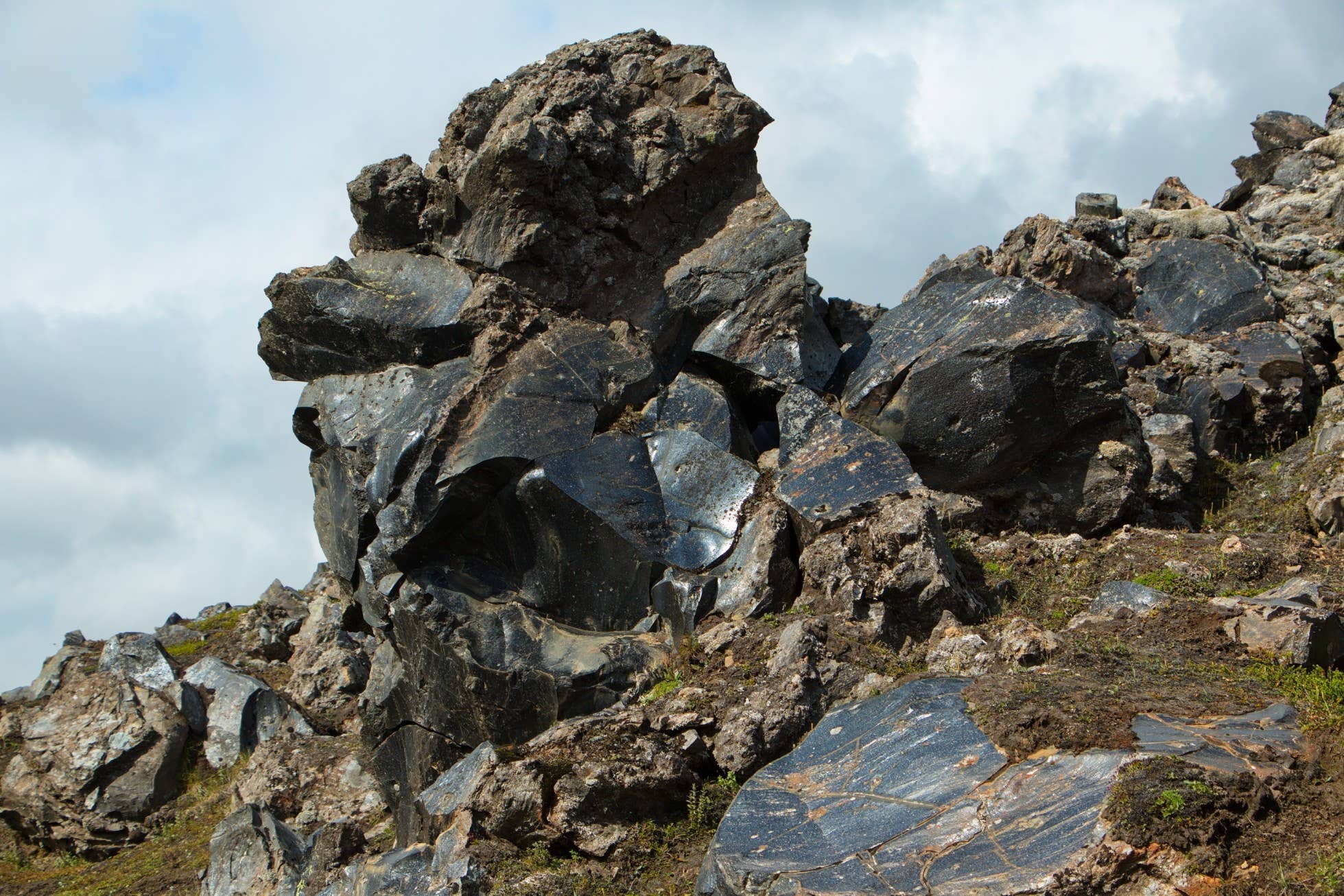 Dark obsidian rocks along the Landmannalaugar to Hrafntinnusker hiking trail.