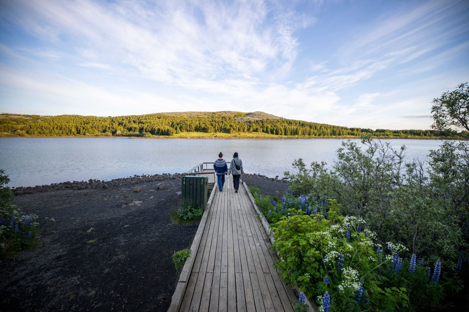 Hvaleyrarvatn lake with green forest and low hills above Hafnarfjörður.