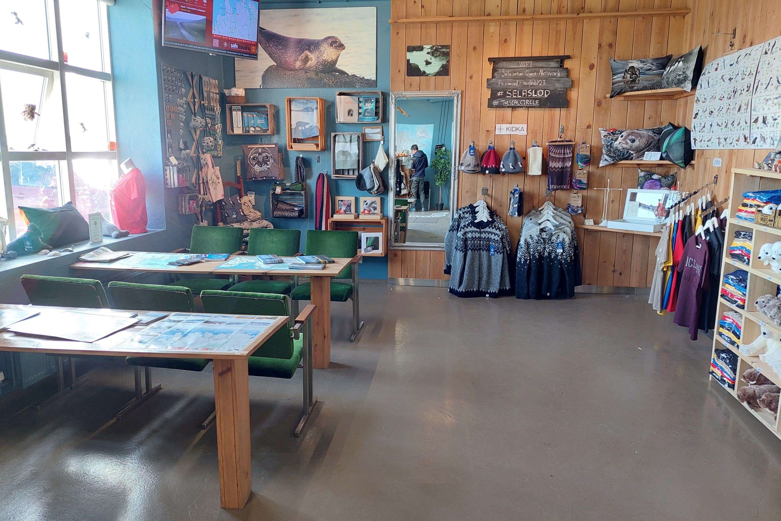 Visitor-information area inside the Icelandic Seal Center with seal displays and local maps.