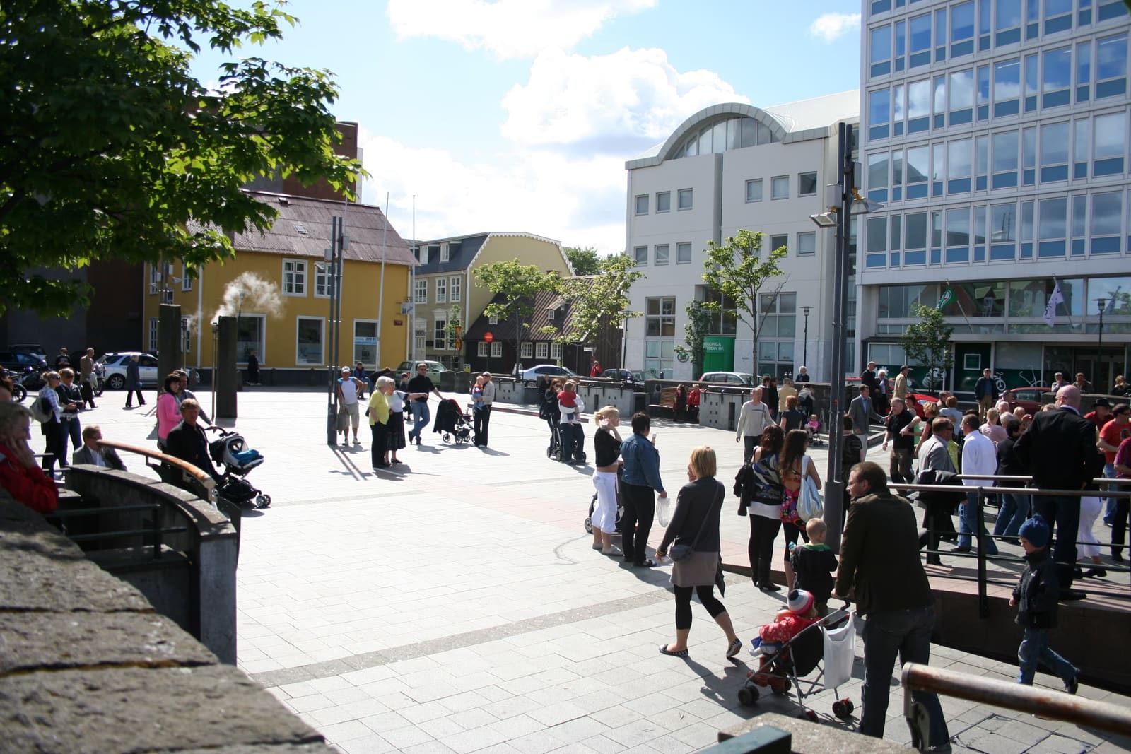People walking through Ingólfstorg Square in downtown Reykjavík on a busy day.