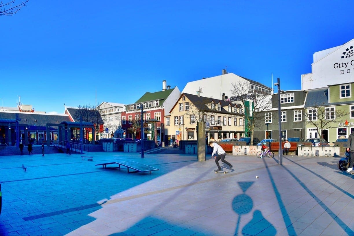 Ingólfstorg Square framed by downtown Reykjavík buildings and walking routes.