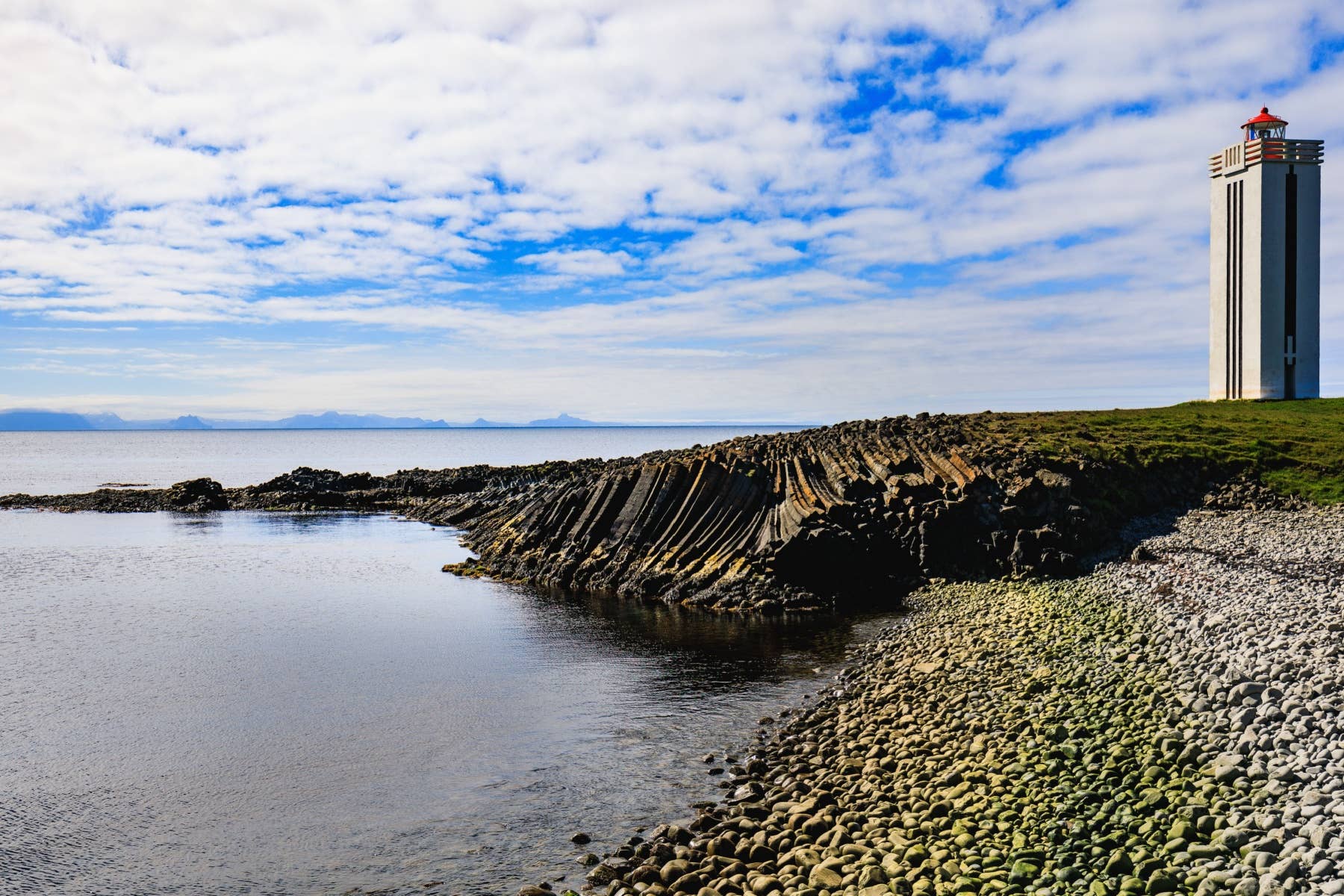Kálfshamarsvík lighthouse and basalt shoreline on the Skagi Peninsula near Ketubjörg.